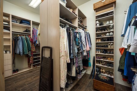Primary closet with lots of storage and built in organizers