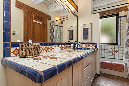 Primary en suite bathroom with view of vanity and bath tub