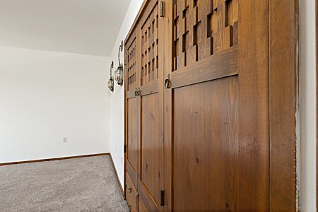 Carved closet doors in the bedroom of 404