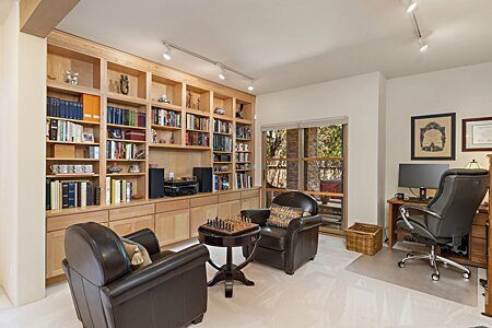 Downstairs Study/Den/TV/Library room with build-in custom maple bookshelves