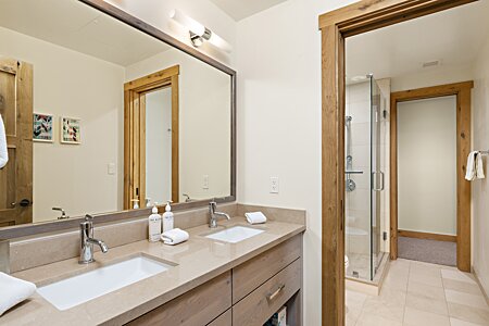 Bath between loft and bunk room with double vanities