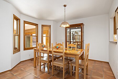 Formal dining room next to kitchen, living and sun rooms