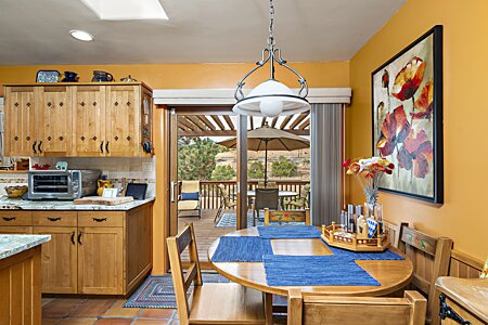 Eat in kitchen area with view out to deck overlooking the backyard