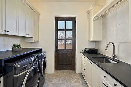 Laundry Room with Utility Sink & access to the Front Entry Courtyard