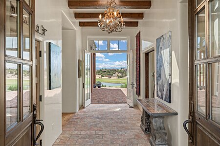 Entering the front door, the immediate view is to the Lake, Golf Course & Mountains
