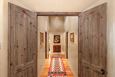 Crafted wood doors and plaster walls within the casita