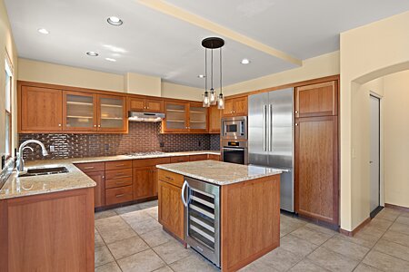 Open and bright Kitchen with plenty of counter space for preparation and a wine cooler in the island