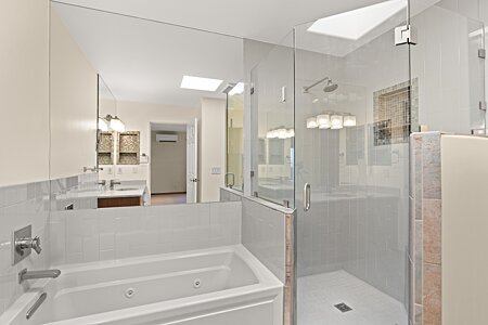 Tub and walk in shower in upstairs primary bedroom