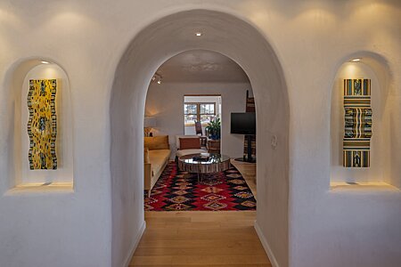 Lighted nichos frame elegant archway to Living Room