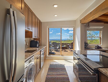 Kitchen features induction cooktop range, custom cabinets & those amazing views