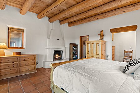 In the main bedroom, An eye level fireplace and Viga ceilings
