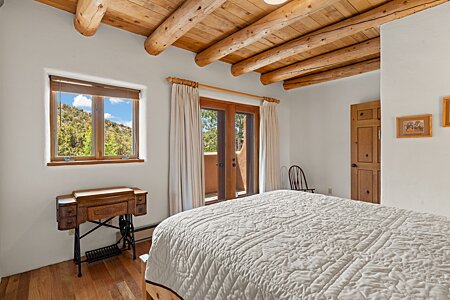 1st Guest bedroom  has wood floors and ceilings, a balcony, and a VIEW!