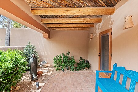 All Santa Fe! Ceiling, floor, corbels, screen door, welcoming, courtyard garden!