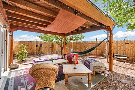 The smaller fenced yard features a lovely Portal for relaxing or entertaining