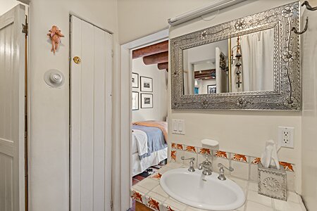 Sink adjacent to Bedroom One with door to Shower / Toilet area on the Left