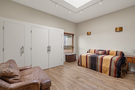 The third bedroom is spacious with lovely new floors, a big skylight, and plenty of closet space