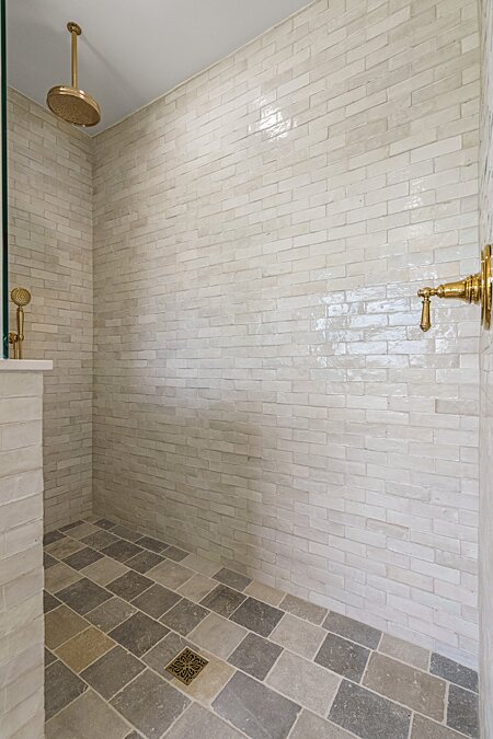 ...and Separate Walk-in Shower with Stone Floor and Custom Tile Enclosure