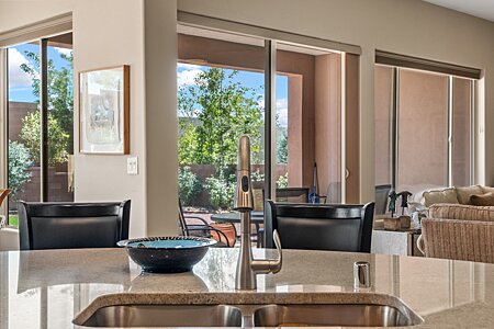 View from Kitchen sink with view out to covered patio for dining