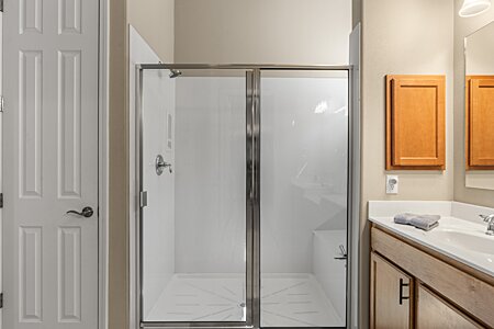 Walk in shower with bench in primary bathroom