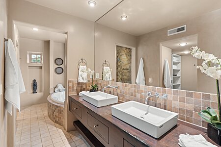 Pair of handsome custom vanities in the large primary bathroom