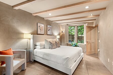 The downstairs second bedroom looks into the green courtyard