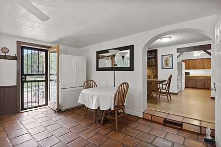 Main house - sunroom/den, view into dining room and kitchen