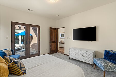 Bedroom Two, with double doors to the West Courtyard & en-suite Bath