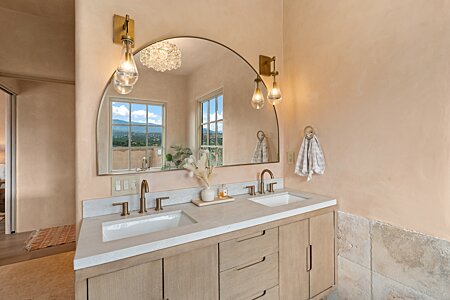 Primary bathroom double vanity and reflected view of the Sangres!