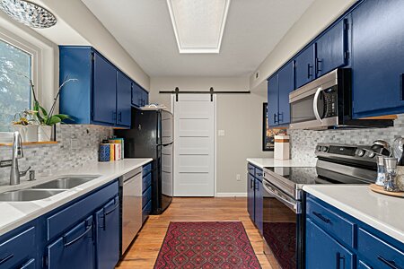 Kitchen with laundry room behind the sliding barn door